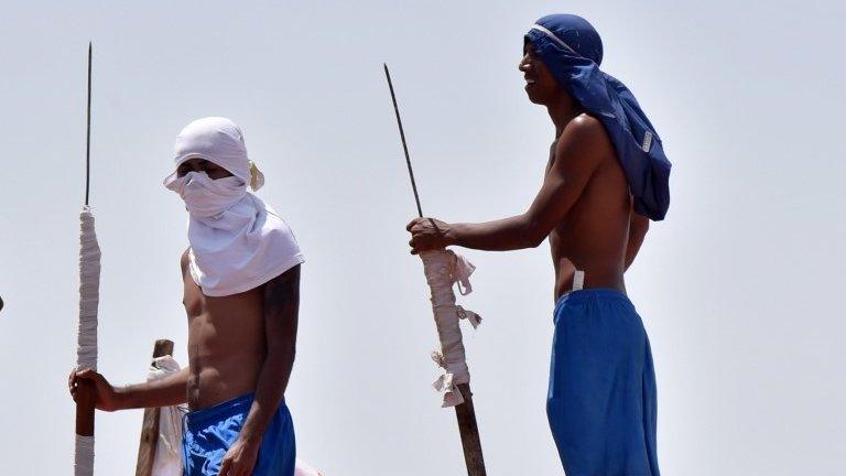 Inmates are seen on a roof during an uprising at Alcacuz prison in Natal, Rio Grande do Norte state, Brazil, January 17, 2017.