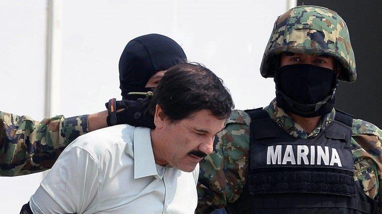 Mexican drug trafficker Joaquin Guzman is escorted by marines as he is presented to the press on 22 February, 2014 in Mexico City