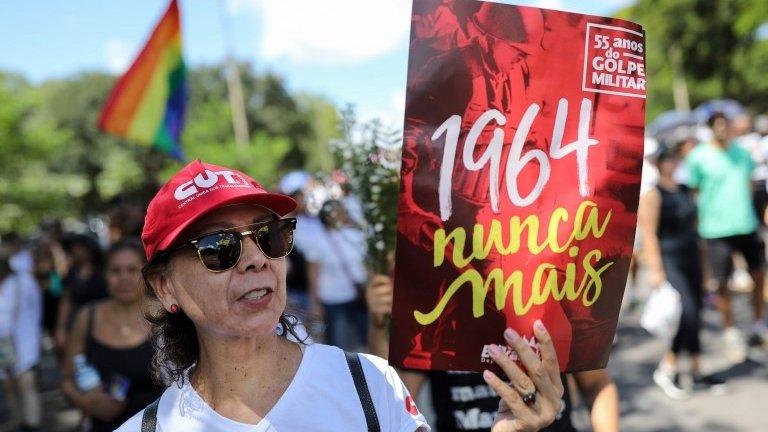 A woman demonstrates against the 1964-1985 dictatorship on the 55th anniversary of the coup, in Brasilia, on March 31, 2019