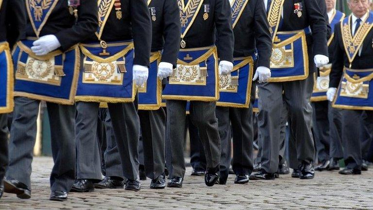 Freemasons march in a procession