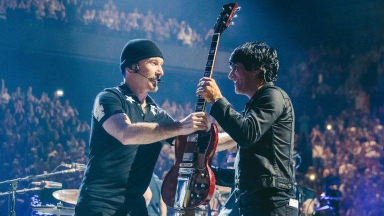 U2's the Edge (left) with member of band Eagles of Death Metal, Paris, 7 December 2015