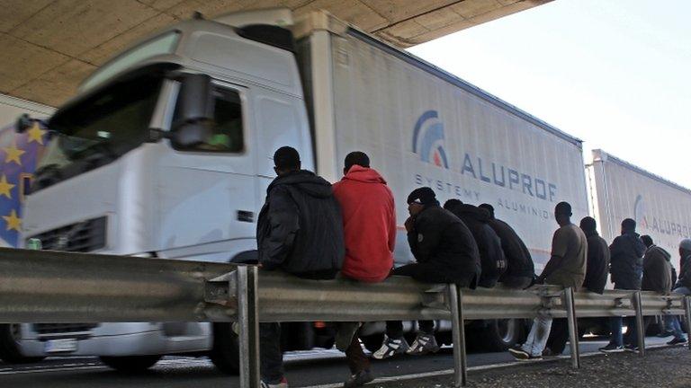 Migrants near trucks heading to the UK