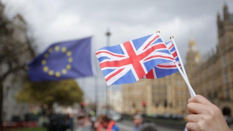 European and UK flags outside parliament