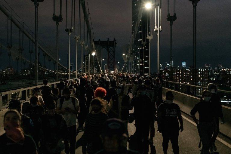 These protesters are leaving the Manhattan Bridge in New York after being stopped by police for hours during a citywide curfew in New York City