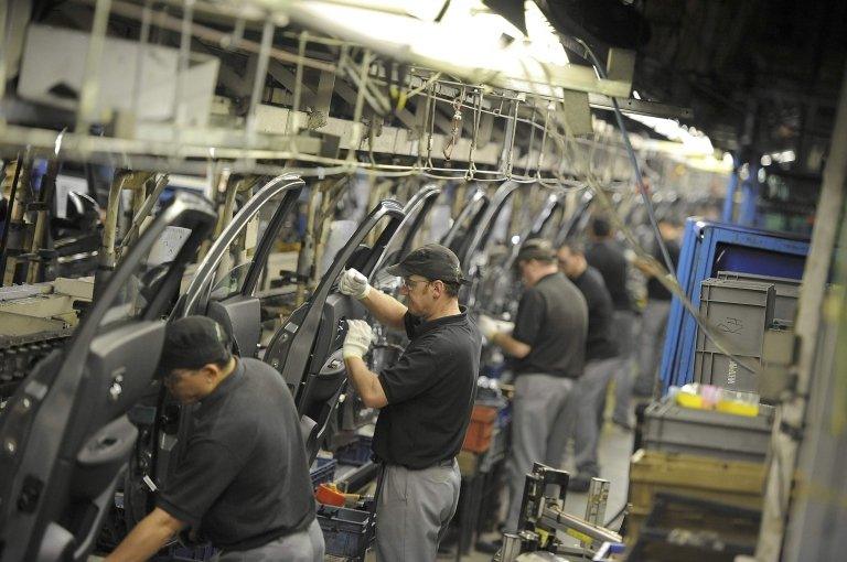 Nissan technicians prepare doors for the Qashqai car at the company"s plant in Sunderland