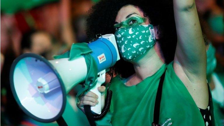 A demonstrator in favour of legalizing abortion uses a megaphone as the senate discuss an abortion bill, in Buenos Aires, Argentina, December 30, 2020