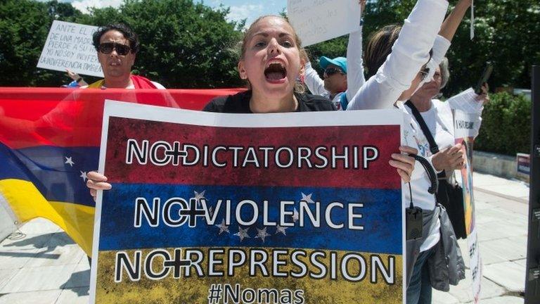 Supporters of the Venezuelan opposition demonstrate in front of the Organisation of American States (OAS) headquarters in Washington, DC, on May 31, 2017 ahead of a meeting of Foreign Ministers of the OAS to discuss the situation in Venezuela.