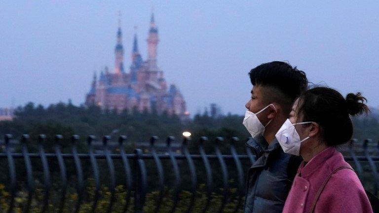 People walk past Shanghai Disney resort - 24 January