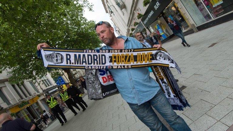 Man selling scarves in Queen Street