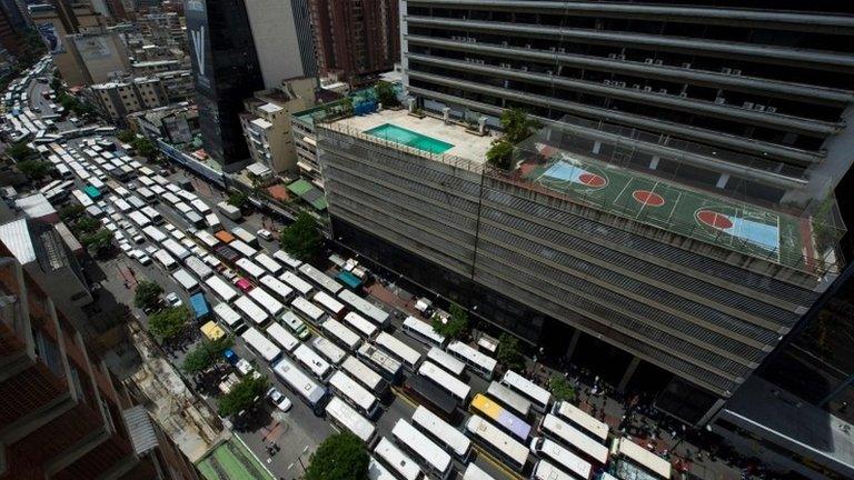 Employers of public transportation block a main avenue in Caracas during a protest due to the shortage in Venezuela of spare parts for their vehicles on September 21, 2016.