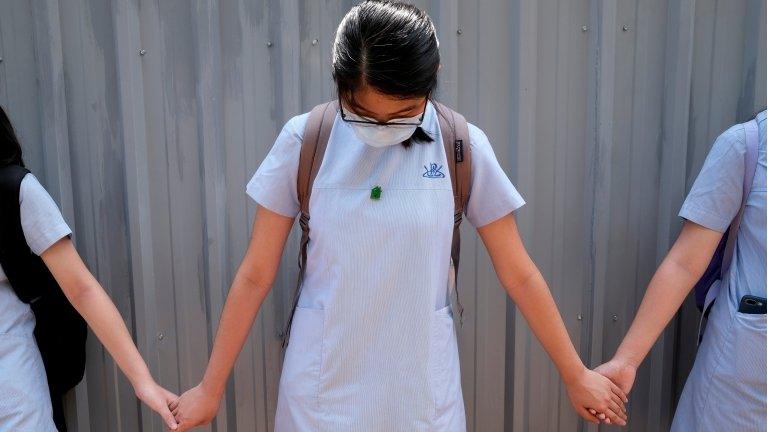 File photo of students forming a human chain in protests in June