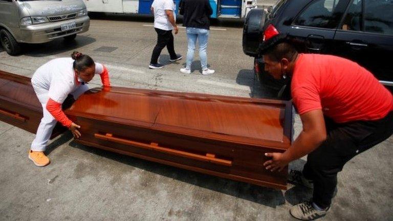 Empty coffins, for the 34 bodies that have been identified so far after the massacre of 68 prisoners, are transferred to the morgue, in Guayaquil, Ecuador, 14 November 2021