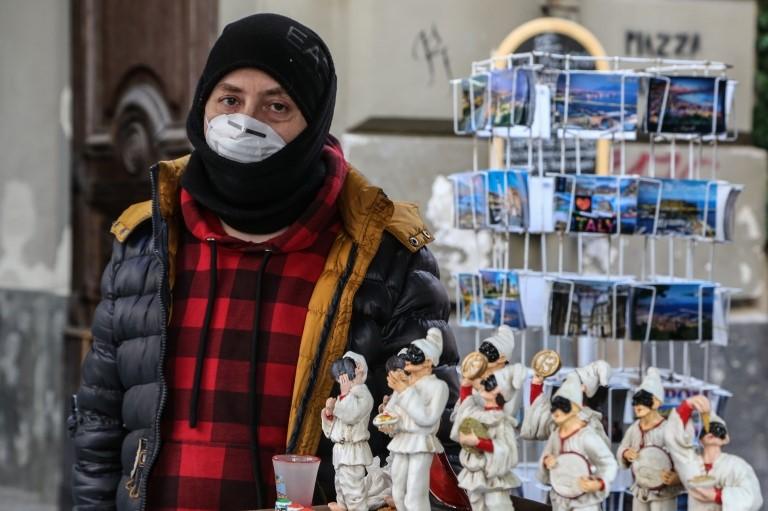 A vendor wears a respiratory mask in Naples