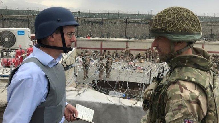 Laurie Bristow (left) speaking to a member of the UK armed forces at Kabul airport