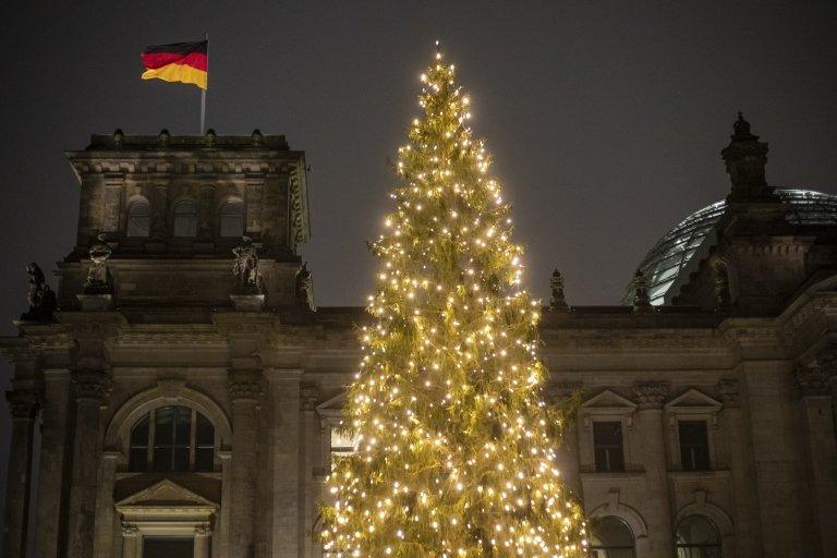 Illuminated Christmas tree stands in front of the German parliament "Bundestag", in Berlin, Germany,