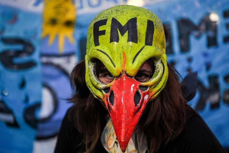 A woman demonstrates while legislators debate a bill to put a stop on public services taxes raising in Buenos Aires, on May 09, 2018.