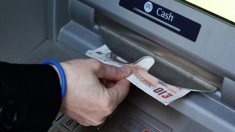 Money being taken out of an ATM