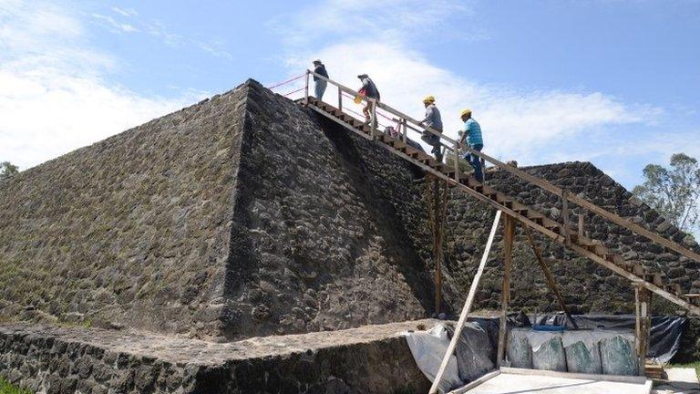 Archaeologists work at the archaeological site of Teopanzolco, Morelos state, Mexico, 11 July 2018.