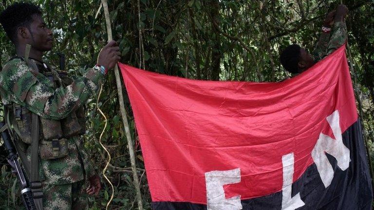 Rebels of the National Liberation Army (ELN) hold a banner in the northwestern jungles in Colombia, August 30, 2017