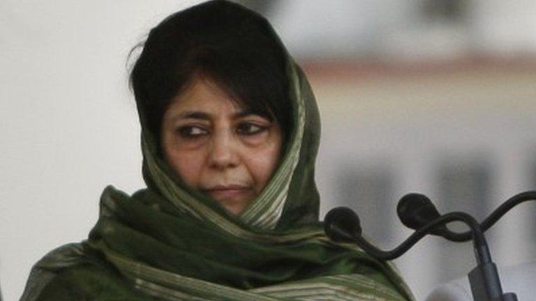 New Indian Kashmir Chief Minister Mehbooba Mufti, center, takes the oath of office during a ceremony in Jammu, India, Monday, April 4, 2016.