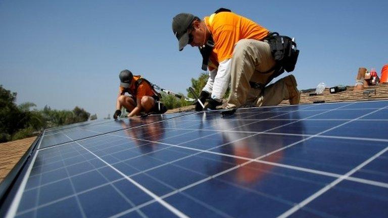 Worker fitting solar panels