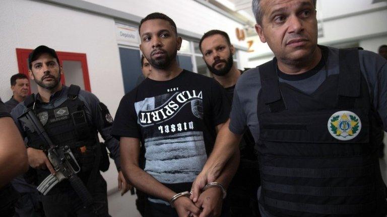 Alleged Rocinha favela drug boss, Rogerio Avelino da Silva (C), nicknamed "Rogerio 157", is escorted by Brazilian Civil Police members at the Police headquarters, after being arrested in Rio de Janeiro, Brazil on December 06, 2017. Brazilian police and soldiers on Wednesday captured one of Rio de Janeiro"s most wanted alleged drug trafficking bosses in a rare high-profile success for the city"s beleaguered security forces