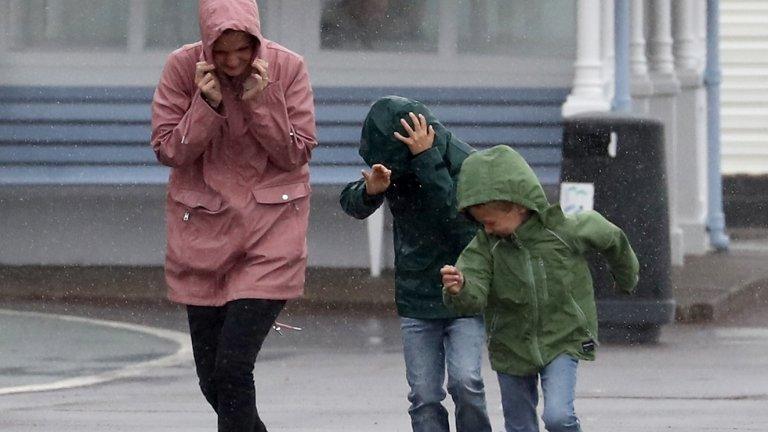 family-getting-blown-by-wind