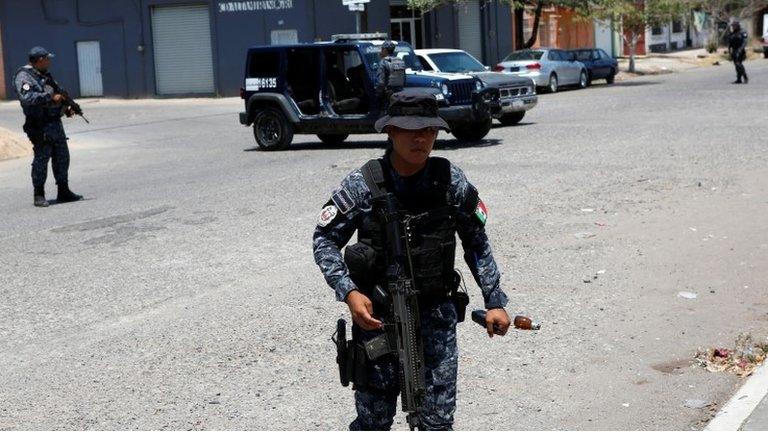 Federal Police agents keep watch as independent presidential candidate Margarita Zavala (not pictured) holds a meeting with residents as part of her campaign in Ciudad Altamirano, in Guerrero state, Mexico April 3, 2018.