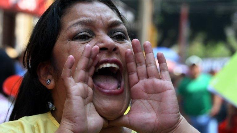 A high-school teacher shouts slogans during a protest against the approval of education and healthcare bills in the Honduran Congress in Tegucigalpa on April 29, 2019.