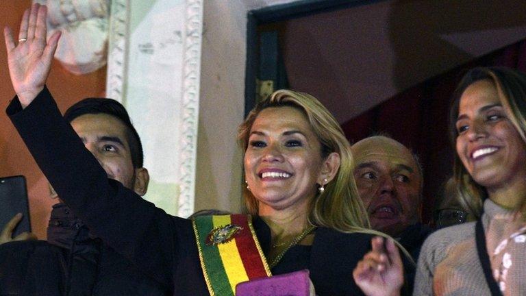 Jeanine Anez, waves from the balcony of the Quemado Palace in La Paz after proclaiming herself Bolivia's new interim president