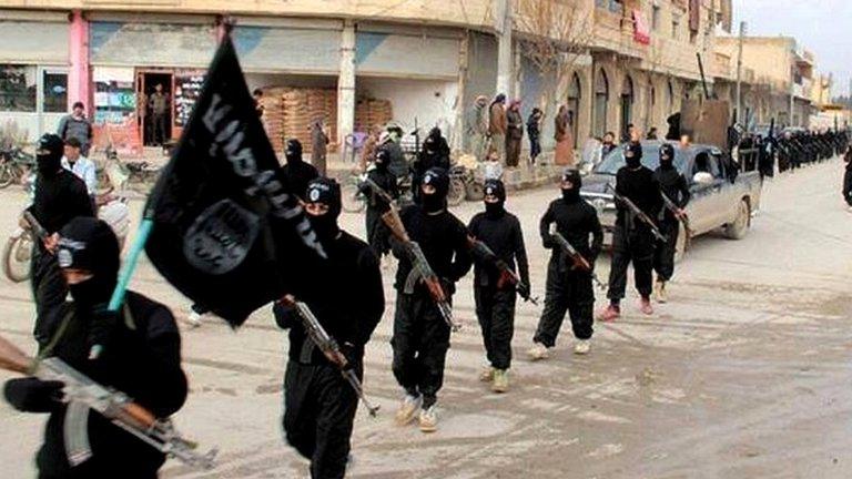 This undated file image posted on a militant website on Tuesday, Jan. 14, 2014 shows fighters from the al-Qaida linked Islamic State of Iraq and the Levant (ISIL) marching in Raqqa, Syria.