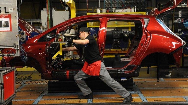 A dashboard being fitted on a manufacturing line.