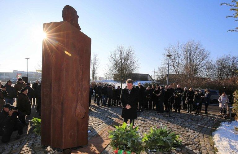 People take part in an hour of commemoration at the memorial for the victims of the KZ-Aussenlager Magda, a forced labour sub-camp of the Buchenwald Nazi death camp