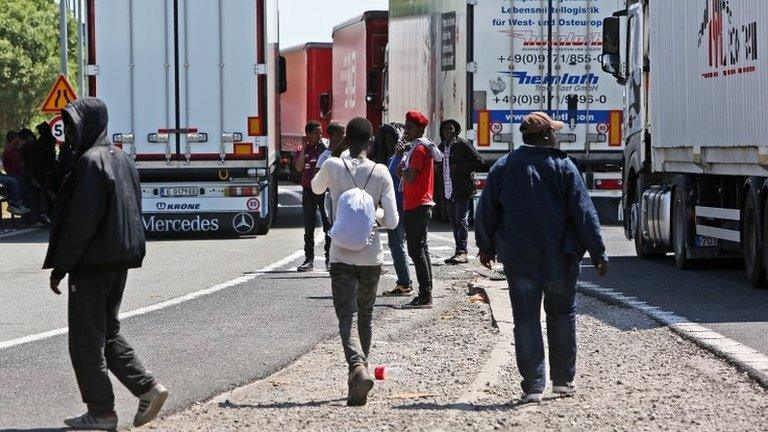 Migrants near trucks heading to the UK