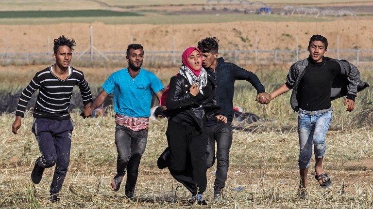 Protesters hold hands and run