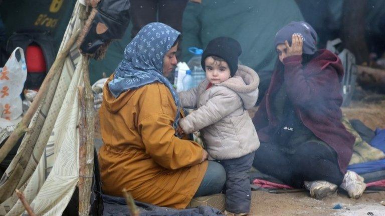 People gather in a makeshift camp on the Belarusian-Polish border in the Grodno region