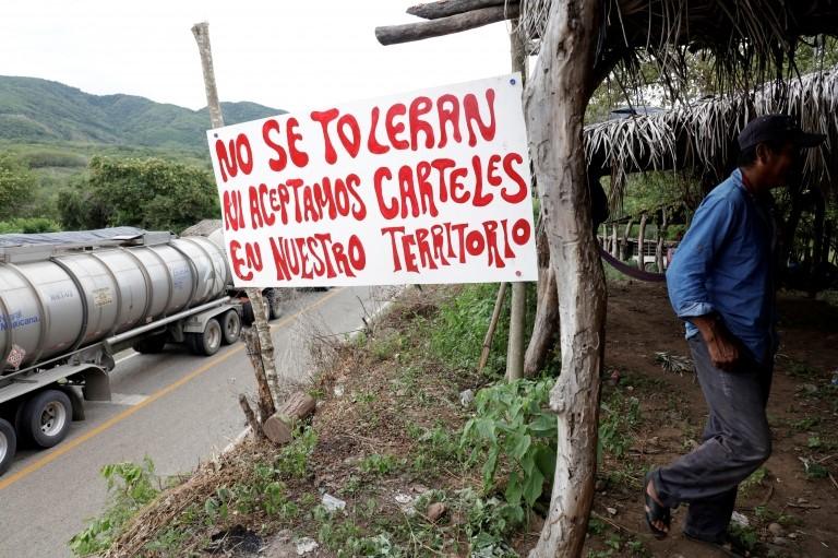 A sign reads: "We do not tolerate nor accept drug cartels in our territory" at a checkpoint in Mexico