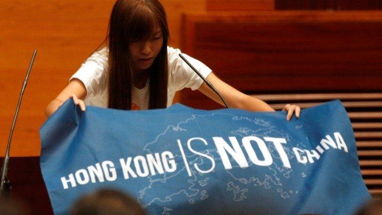 Newly elected lawmaker Yau Wai-ching displays a banner before taking oath at the Legislative Council in Hong Kong, China October 12, 2016.