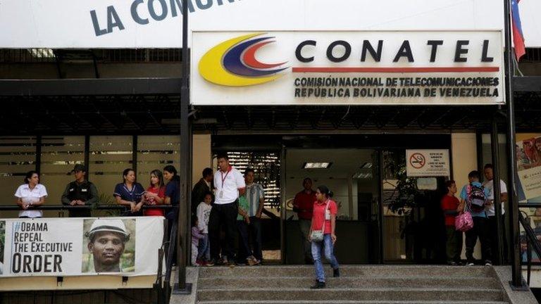 A woman walks out from the building of the National Commission of Telecommunications (CONATEL), in Caracas, Venezuela February 16, 2017