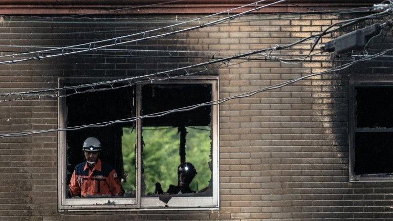 Emergency services workers inspect a room inside the Kyoto Animation Co studio