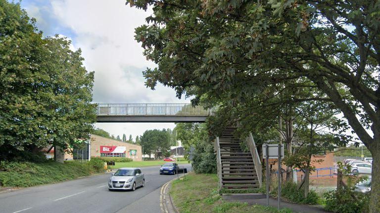 The footbridge that links Westgate Island with Westgate Street, with cars passing beneath it