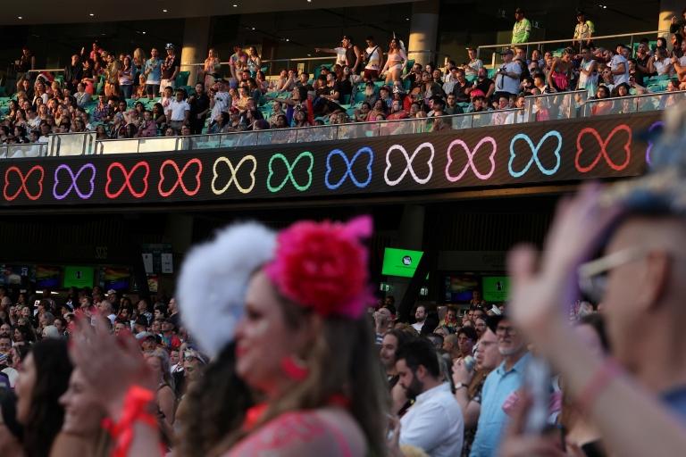 A large crowd are seen inside cricket stadium celebration