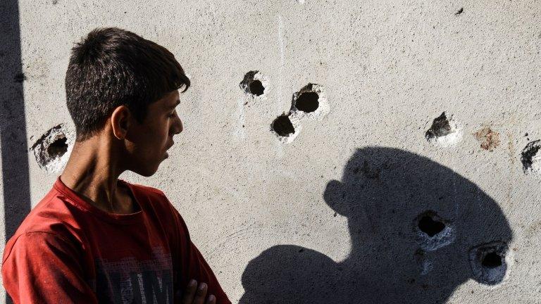 Boy looks at marks of explosion at Gaziantep wedding, 21 August 2016