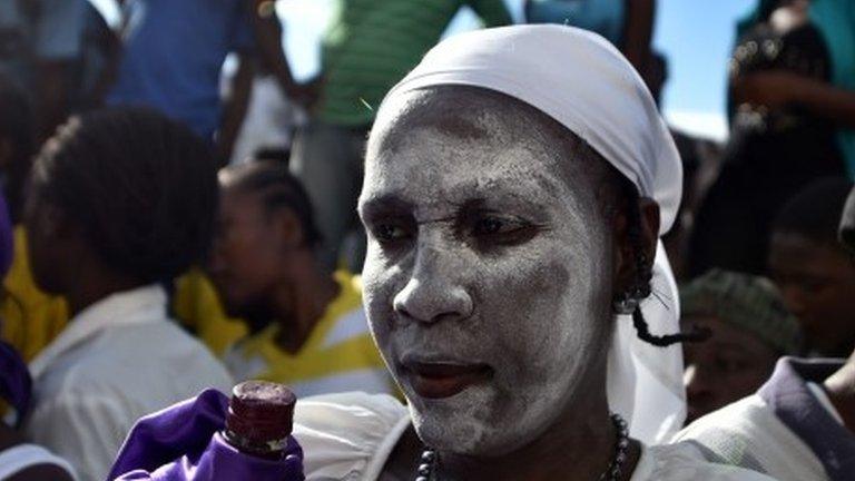 A devotee in the role of a spirit known as a Gede is seen during ceremonies honouring the Haitian voodoo spirits of Baron Samdi and Gede in Port-au-Prince on 1 November, 2015