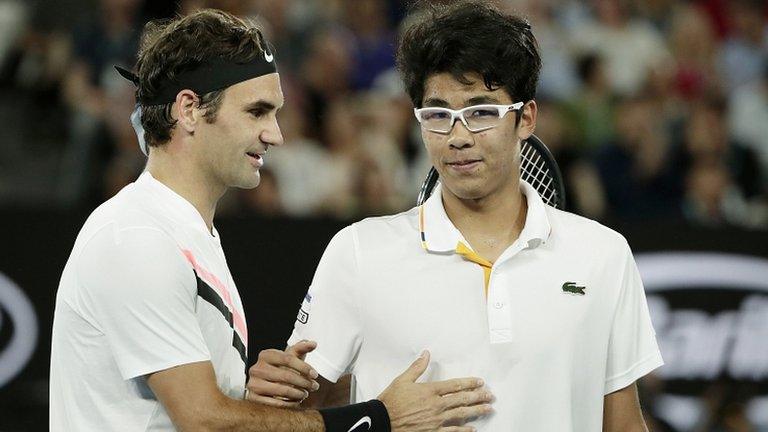 Federer commiserates with Chung at the end of their match