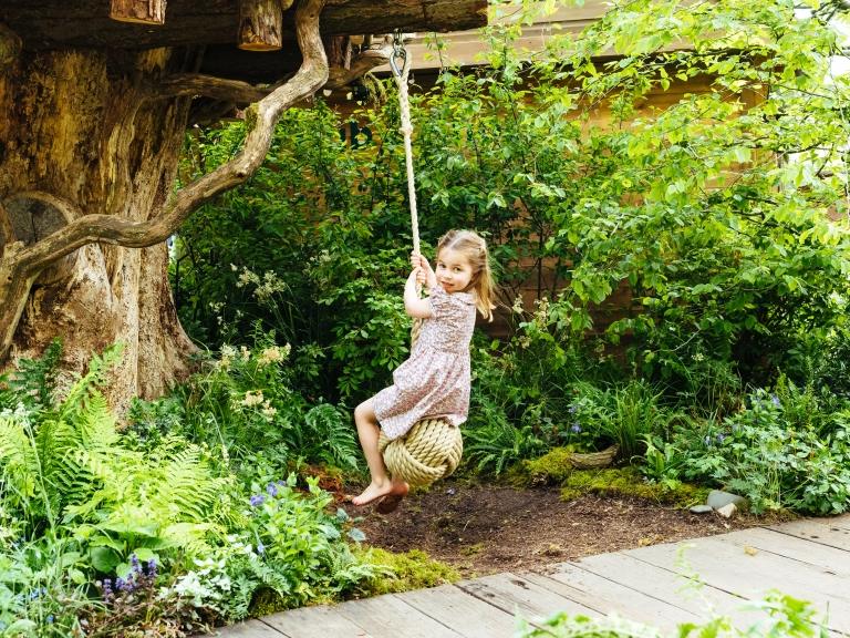 Charlotte-playing-on-a-swing.