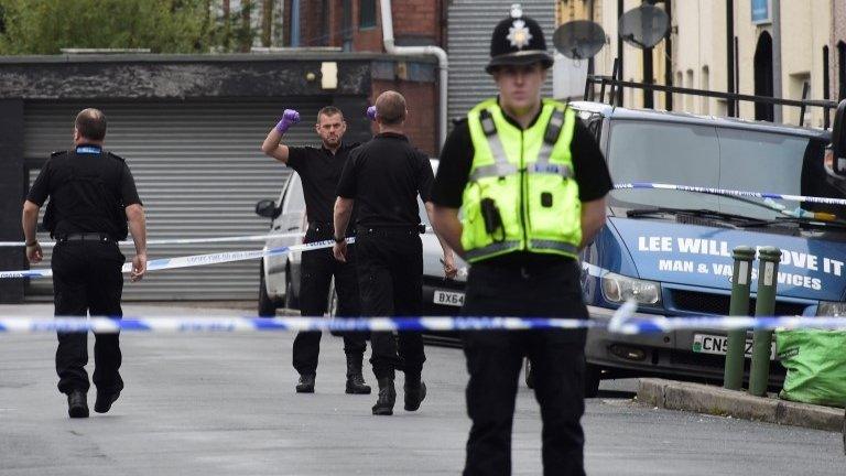 Officers stand behind police cordon