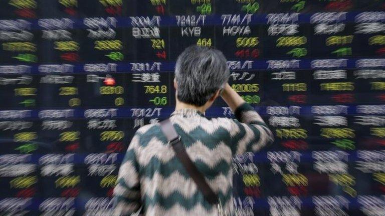 Woman looking at Japan share board