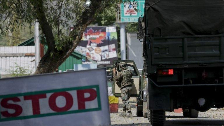 An Indian army soldier arrives at the army base which was attacked by suspected rebels in the town of Uri, west of Srinagar,