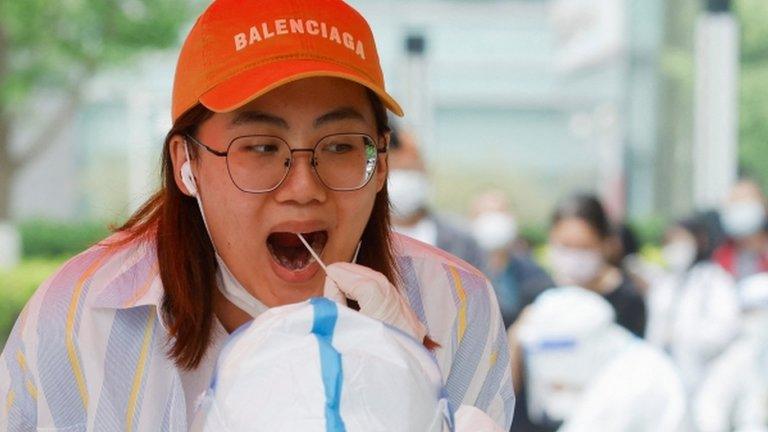 A woman in Beijing has a covid test